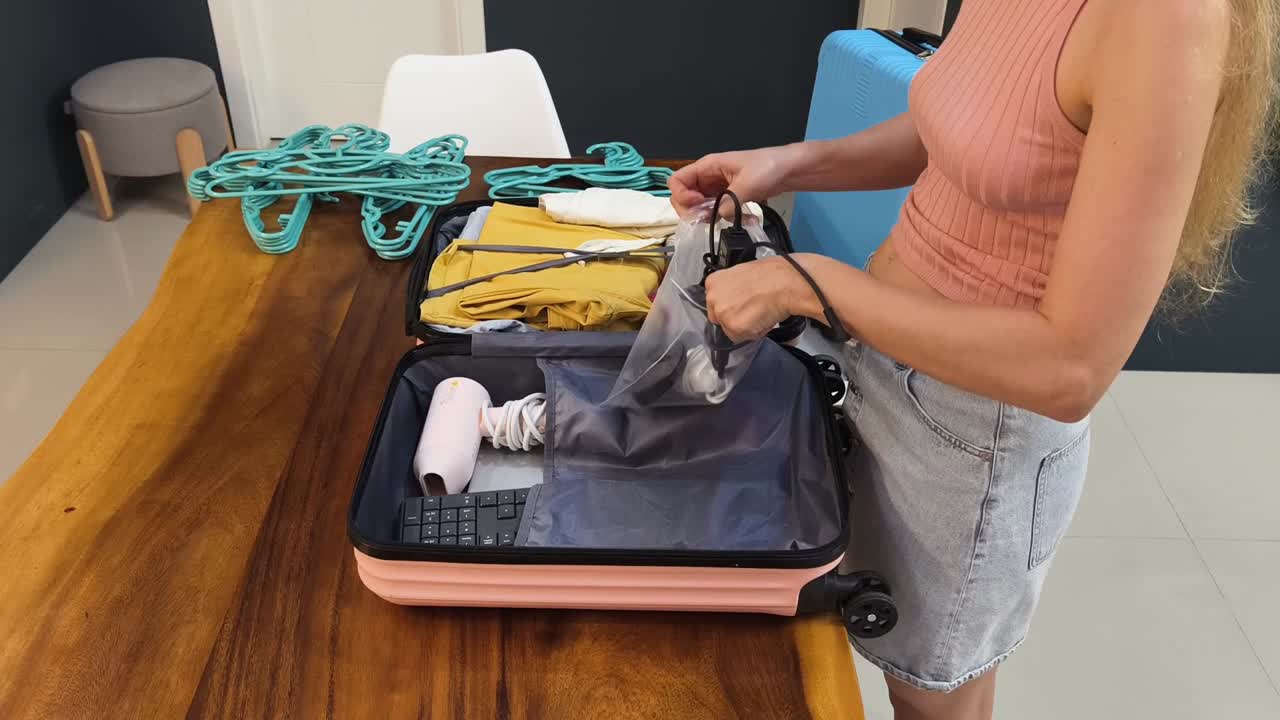 Woman packing suitcase for travel