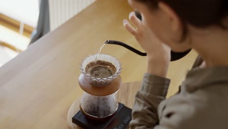 woman brewing pour over coffee