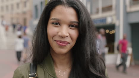 portrait-of-cheerful-young-mixed-race-woman-on-vacation-laughing-happy-enjoying-lifestyle-running-hand-through-hair