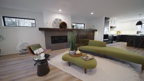 modern living room with a long green couch, fireplace, and some retro design and decorations