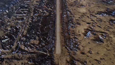 drone captures remote airfield runway cutting through barren spring landscape 4k