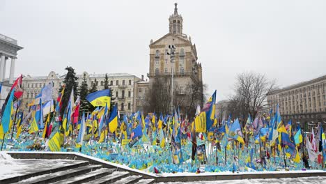 ukrainian and international flags line a war memorial in kyiv’s independence square, paying tribute to fallen soldiers—a moving display of remembrance and loss in the ongoing conflict.