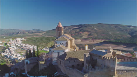 aerial panoramic view of the castle of iznájar and it's surrounding town