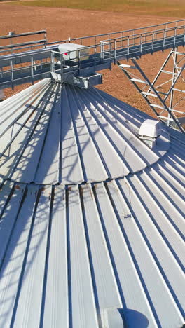 aerial view. metal grain elevator in agricultural zone. grain warehouse vertical video
