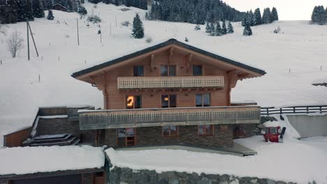 Aerial-overview-of-a-luxurious-chalet-in-a-snow-covered-landscape