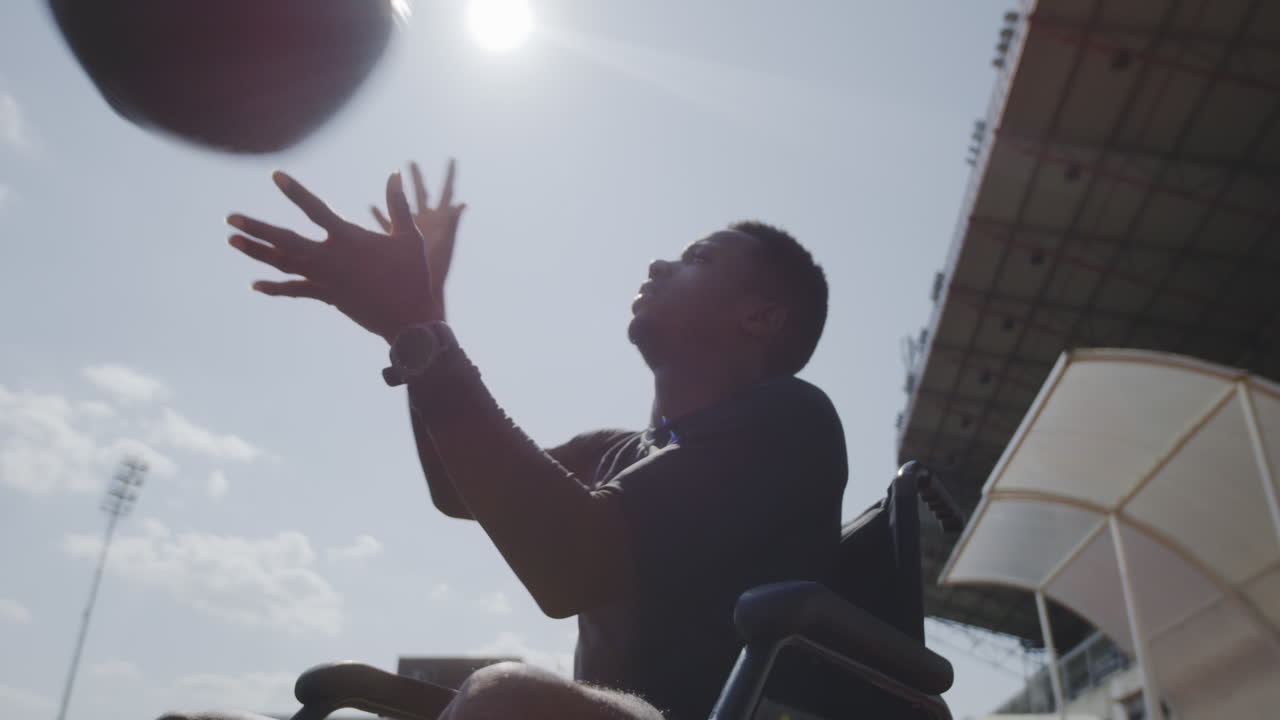 Disabled Person Exercising with Medicine Ball in Stadium