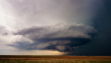 dramatic supercell storm cloud over a field