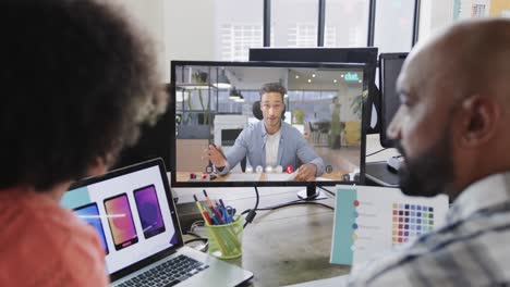 African-american-business-people-on-video-call-with-caucasian-male-colleague-on-screen