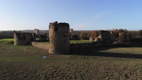 Ancient-Flint-castle-medieval-heritage-military-Welsh-ruins-aerial-view-landmark-low-angle-right-orbit-pull-back