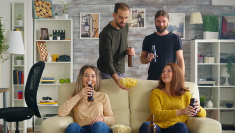 Un-Joven-Ofrece-Patatas-Fritas-A-Una-Chica-Mientras-Ve-Un-Partido-En-La-Televisión.