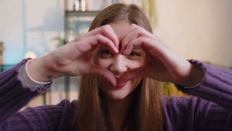 woman making a heart shape with her hands