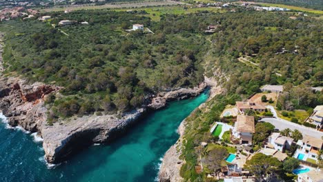 Clear-turquoise-blue-sea-water-at-a-remote-natural-bay-with-white-sand-beach