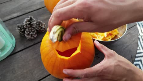 close-up of male hands opening and closing jack-o-lantern