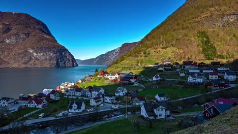 shot over a beautiful village on a sunny evening time in lofoten, norway surrounded by mountainous terrain in timelapse