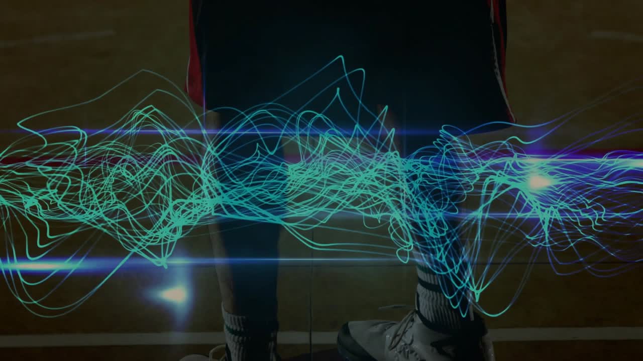Basketball player adjusting stance, camera lift causing turquoise wave sweeping court for training