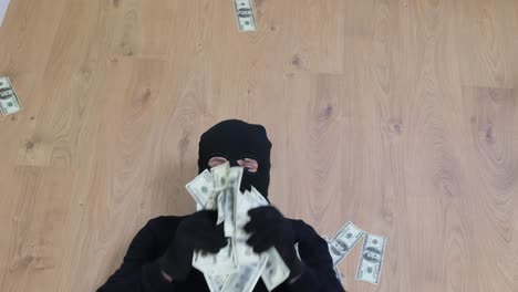 robber lying on floor with money