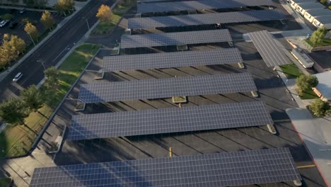 solar panels covering a high school parking lot at sunset, aerial view