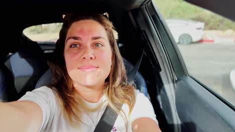 young woman creating vlog inside car