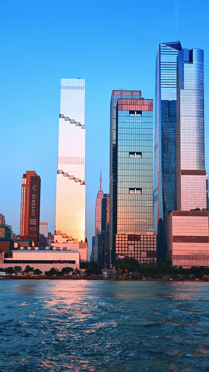 Nova York, EUA, 8 de agosto de 2025: reflexos do pôr do sol em torres de vidro modernas. As cores do pôr do sol se refletem nas altas torres modernas que cercam o distrito de Hudson Yards.