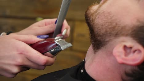 man getting a beard trim at the barbershop