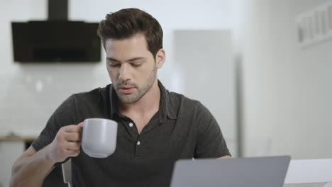 Business-man-working-at-laptop-at-remote-workplace.-Black-guy-cleaning-table.