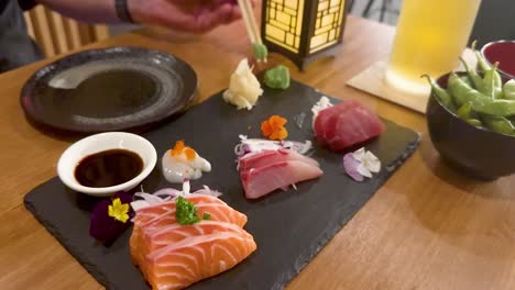 sushi and sashimi served with soy sauce