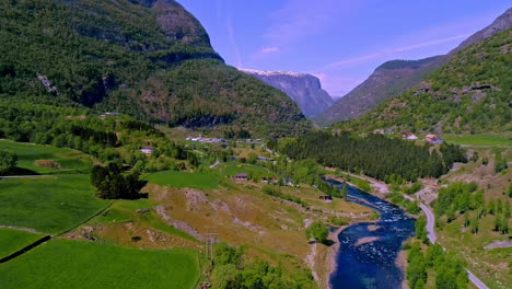 deep blue river flow through green forestry mountains valley, aerial view