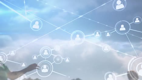 animation of network of connections with people icons over football players practicing