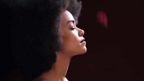 black woman, red rose petals