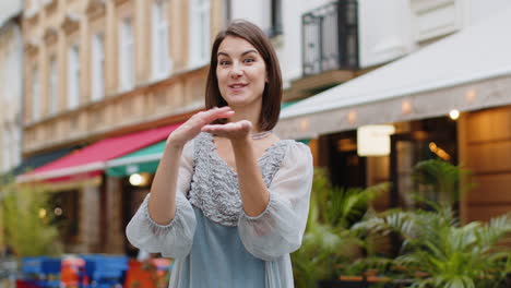 cheerful rich woman showing wasting throwing money, win lottery, share, celebrate in city street