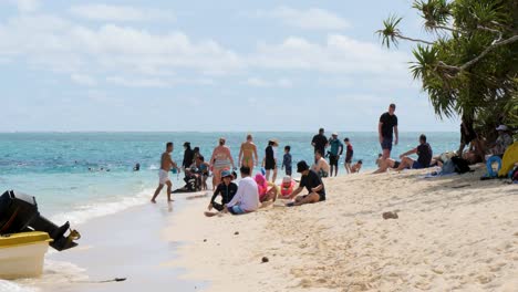 cruise ship passengers on the small beach of mystery island, vanuatu.