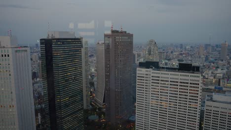 tokyo japan, shinjuku skyline in early evening on overcast day 4k