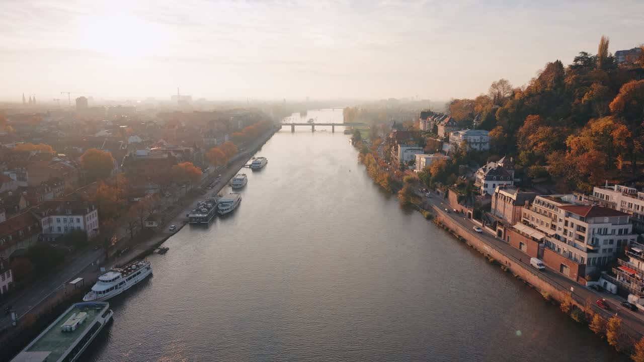 High-Altitude Aerial Panorama of Heidelberg's Historic Old Town, Neckar River Bend, and Castle nestled in the Mountain Valley at Sunset