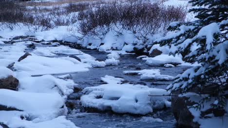 dreamy icy river flowing in assiniboine national park, canada