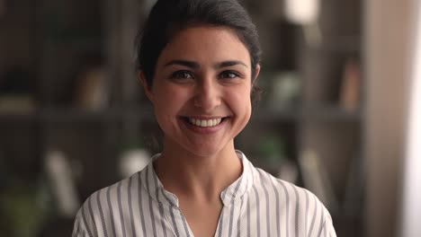 headshot portrait pretty woman standing indoor smiling looking at camera