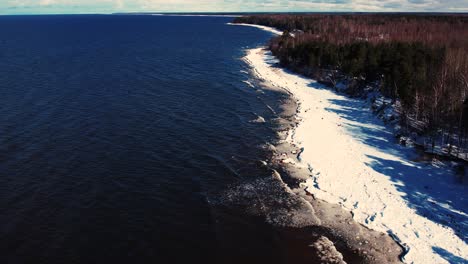 drone flight over the sea in winter frozen rocks on the coast