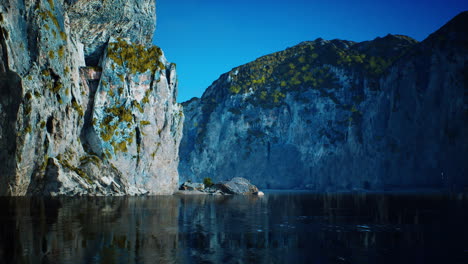 rocky cliffs in the ocean at sunny day