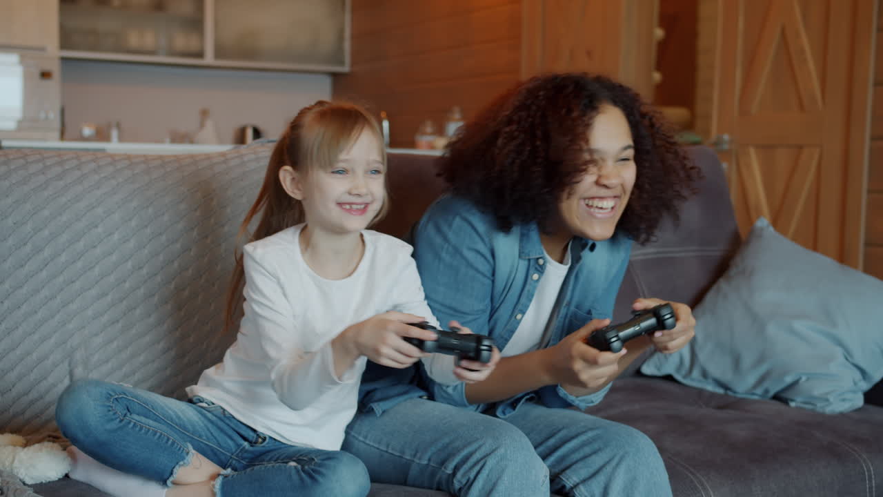 Two Girls Playing Video Games on a Couch