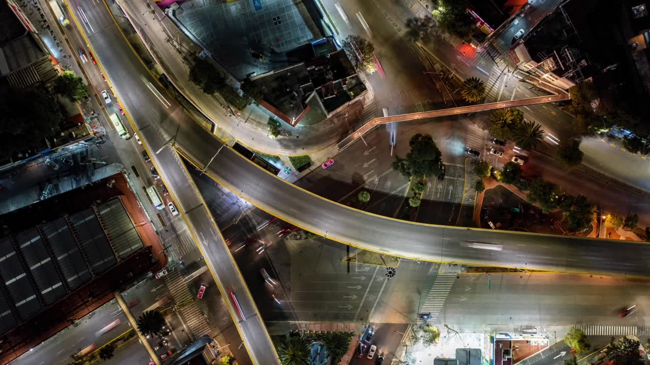 Aerial Hyperlapse view above traffic at major highway at night, in Mexico city, America - Top down, time lapse, drone shot nocturnal Mixcoac