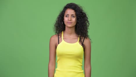 young beautiful hispanic woman pointing finger