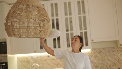 a beautiful pregnant woman tidying her home, engaged in household chores. the scene captures domestic life, maternity, and the balance of routine and preparation during pregnancy