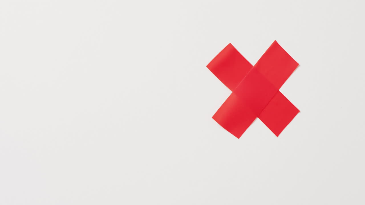 Video of close up of multiple red tapes forming cross and copy space on white background