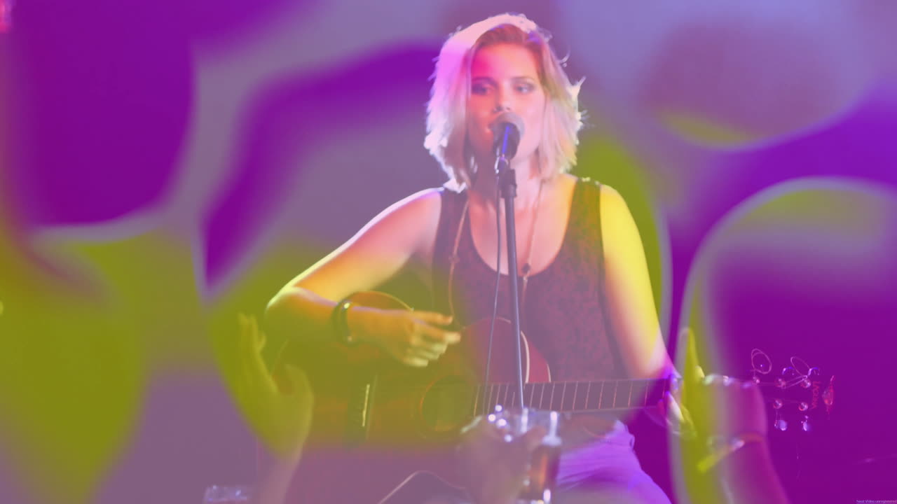 Female musician strumming acoustic guitar on music stage, with animated music notes and lighting