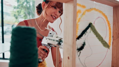 woman creating a needlepoint design