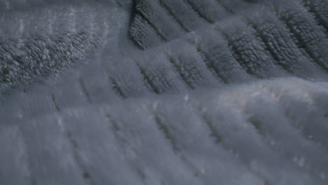 close-up abstract grey fabric texture with wavy ridges