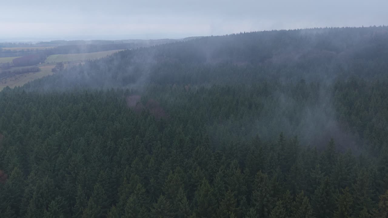 Thick fog drifting across rolling hills creating an eerie fall atmosphere