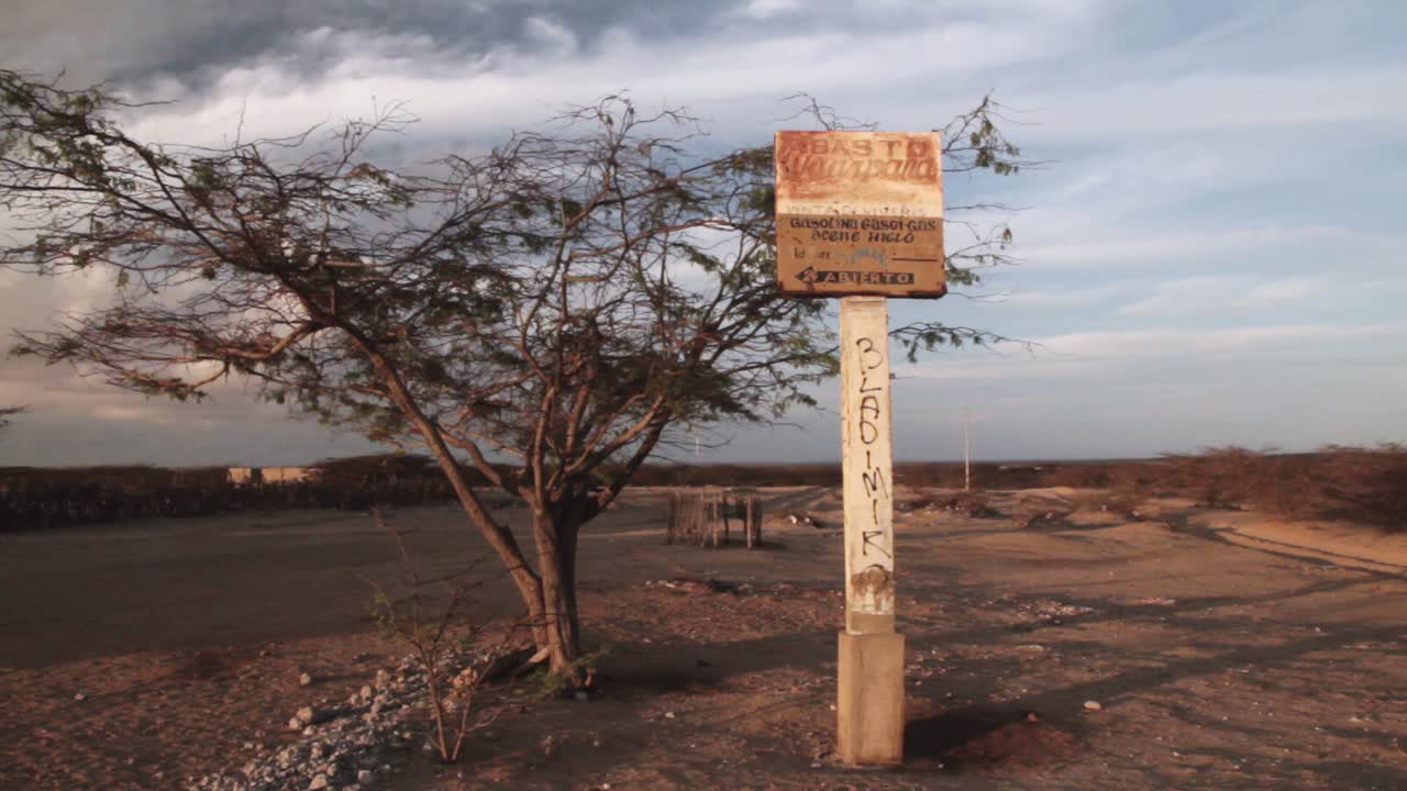 Long shot of petrol station sign ruins at the Guajira desert, northern Colombia