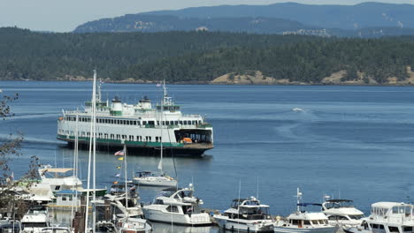 washington passenger and car ferry sailing past marina with sailboats