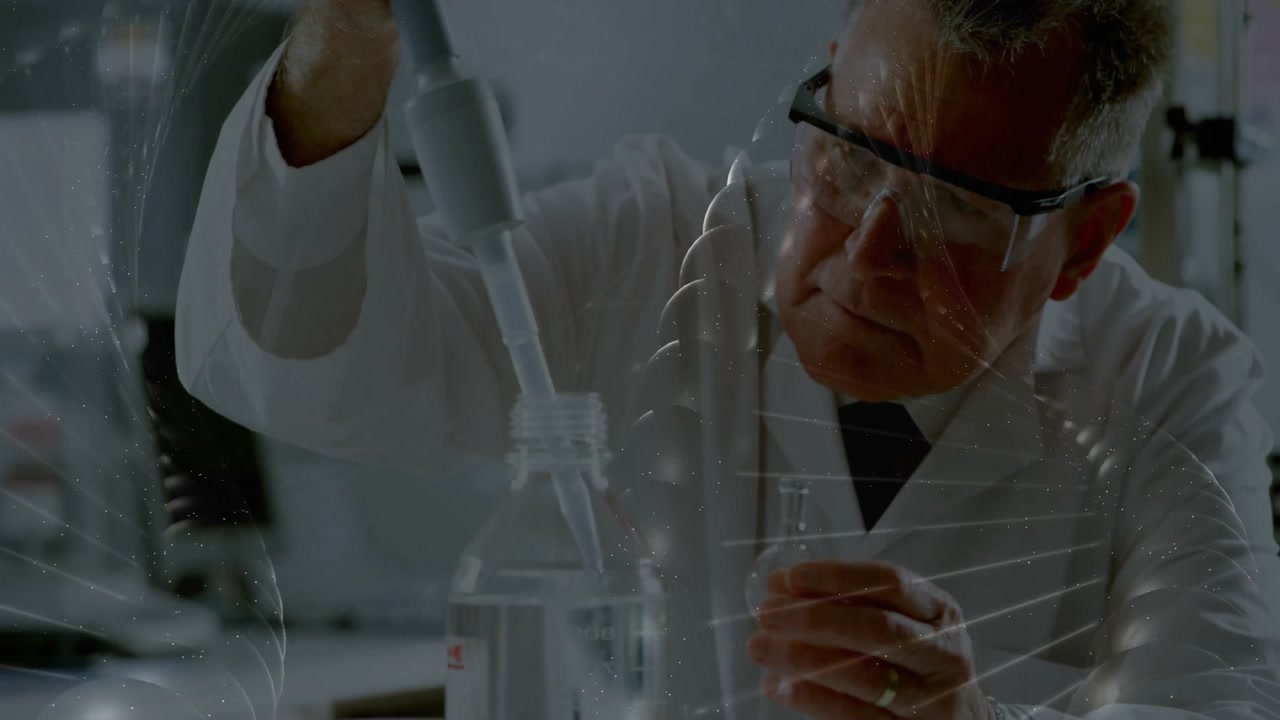 Senior scientist reaching for pipette pipetting liquid into flask ensuring accuracy in research lab