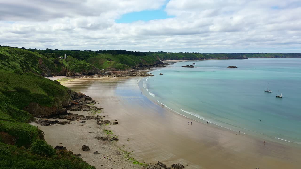 Smooth vertical tilted drone movement to the tropical Gwin Zégal beach bay and shoreline, Côtes-d'Armor, Brittany, France.